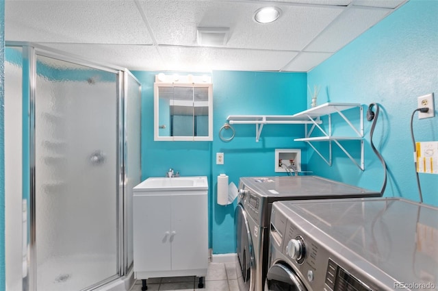 16841 E Hialeah Ave, Centennial, CO 80015 - washroom with washing machine and dryer and light tile patterned floors