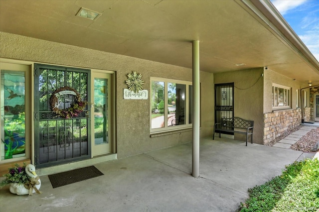 4790 W Lakeridge Rd, Denver, CO 80219 - view of exterior entry featuring stucco siding and stone siding