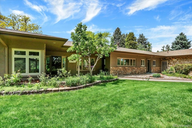 4790 W Lakeridge Rd, Denver, CO 80219 - back of house with a yard, stucco siding, and stone siding