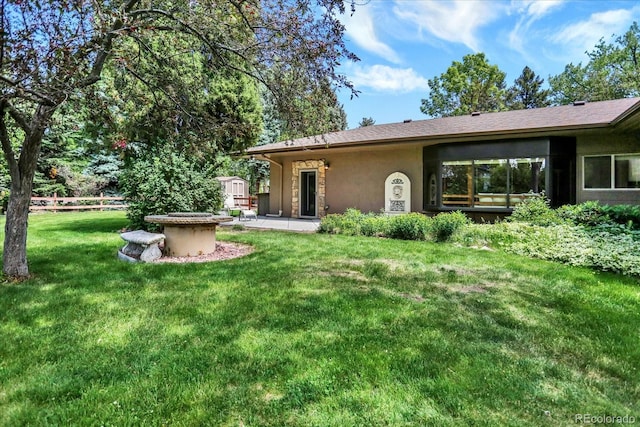 4790 W Lakeridge Rd, Denver, CO 80219 - rear view of house featuring stucco siding and a patio
