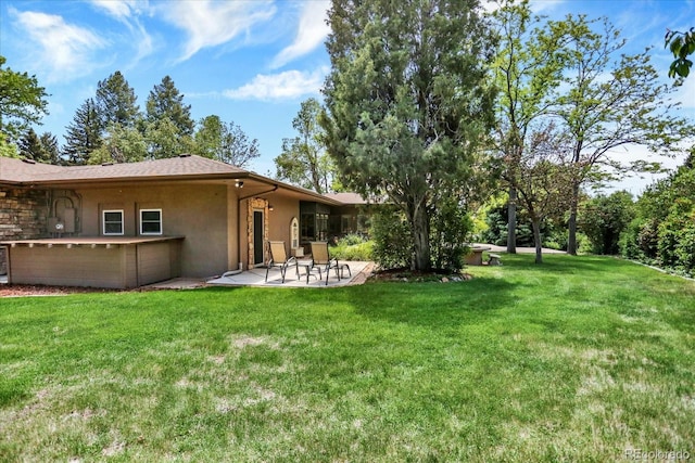 4790 W Lakeridge Rd, Denver, CO 80219 - view of grassy yard with a patio