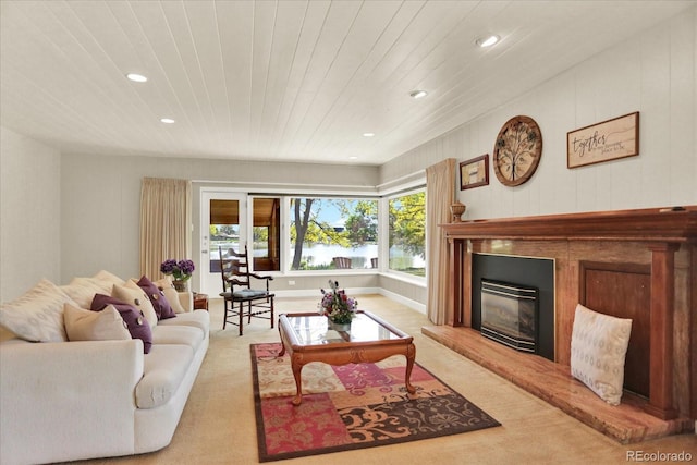 4790 W Lakeridge Rd, Denver, CO 80219 - living room featuring light colored carpet, recessed lighting, wood ceiling, a glass covered fireplace, and a water view