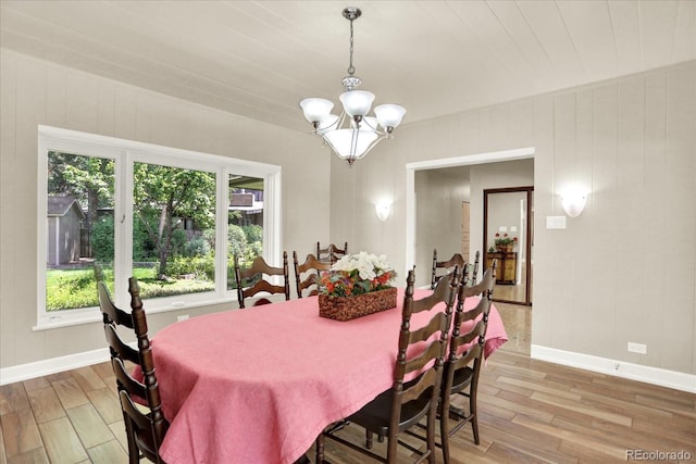 4790 W Lakeridge Rd, Denver, CO 80219 - dining room featuring light wood-style flooring, a chandelier, and baseboards