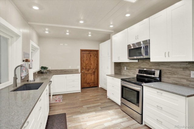 4790 W Lakeridge Rd, Denver, CO 80219 - kitchen featuring stainless steel appliances, a sink, light stone counters, recessed lighting, and backsplash