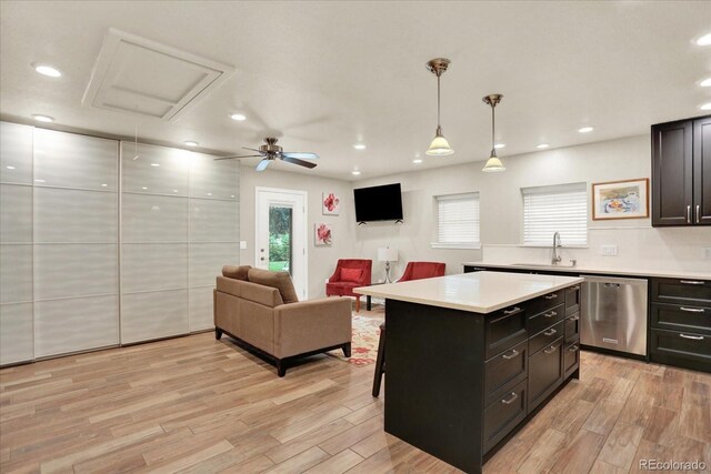 4790 W Lakeridge Rd, Denver, CO 80219 - kitchen featuring dishwasher, light countertops, light wood-type flooring, and recessed lighting