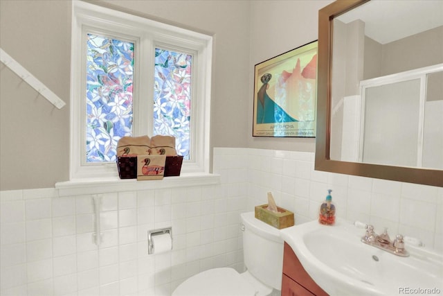 4790 W Lakeridge Rd, Denver, CO 80219 - bathroom with vanity, toilet, tile walls, and wainscoting