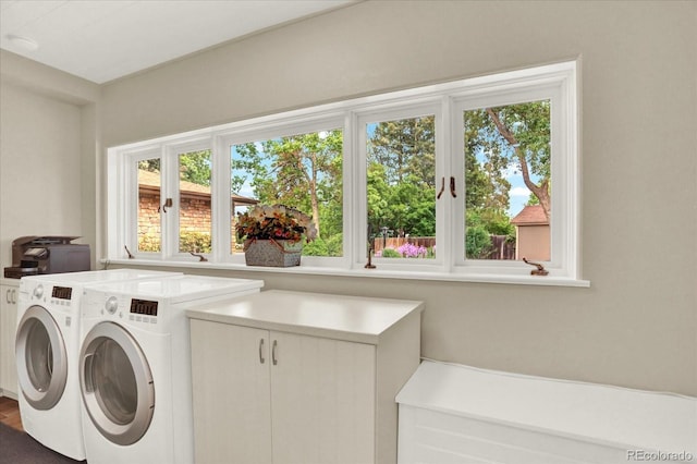 4790 W Lakeridge Rd, Denver, CO 80219 - laundry room featuring washer and clothes dryer, cabinet space, and healthy amount of natural light