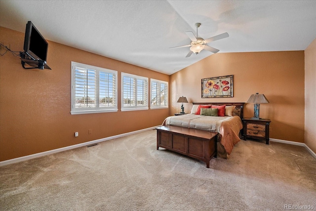 carpeted bedroom featuring ceiling fan, vaulted ceiling, and a textured ceiling