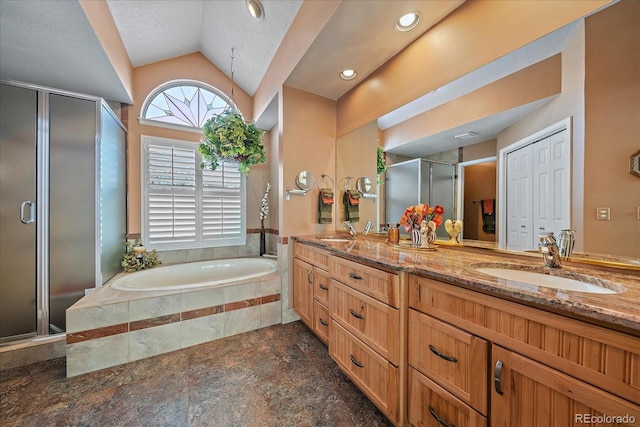 bathroom featuring lofted ceiling, independent shower and bath, and vanity