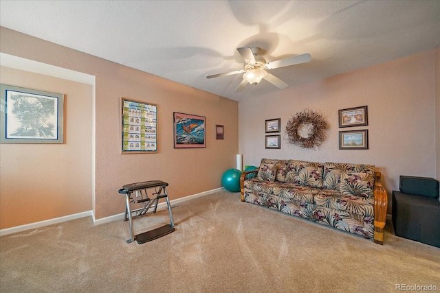 carpeted living room with ceiling fan