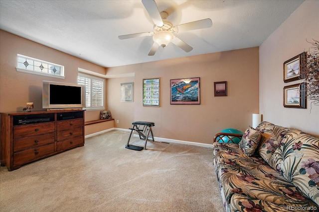 living room with light colored carpet, a textured ceiling, and ceiling fan