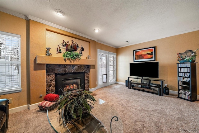 carpeted living room featuring a fireplace, ornamental molding, and a textured ceiling