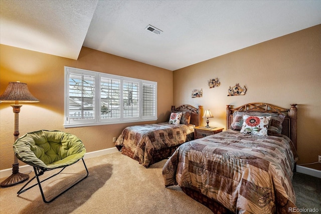 carpeted bedroom featuring a textured ceiling