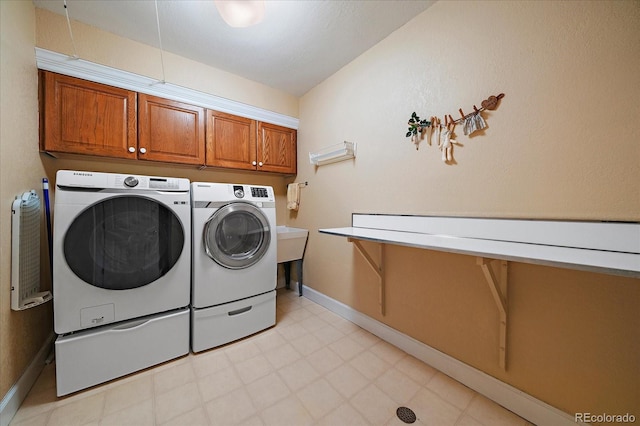 laundry area with cabinets and washing machine and dryer