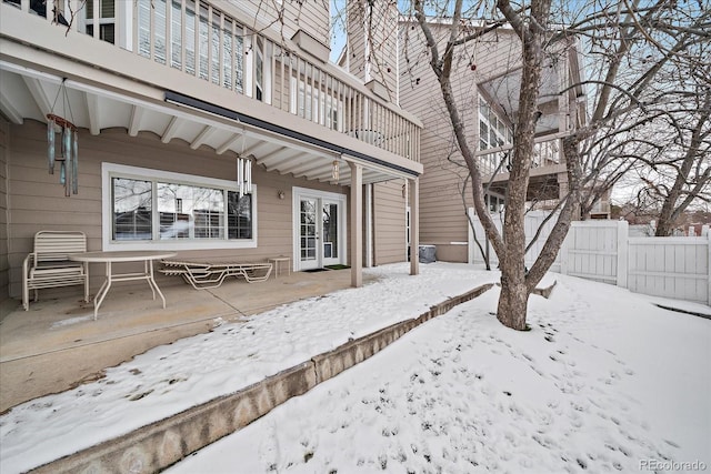 exterior space featuring a balcony and french doors