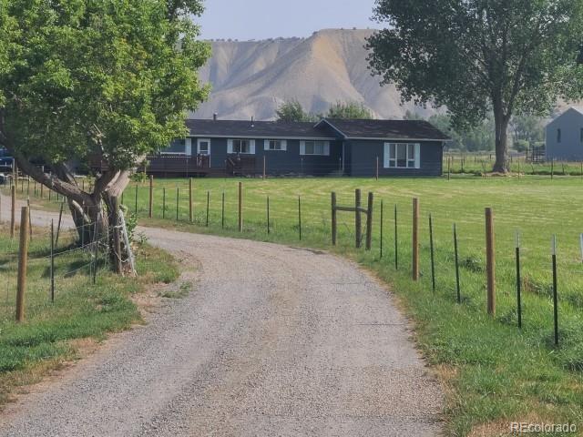 exterior space with a rural view and a mountain view