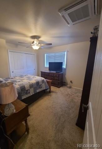 carpeted bedroom featuring an AC wall unit and ceiling fan