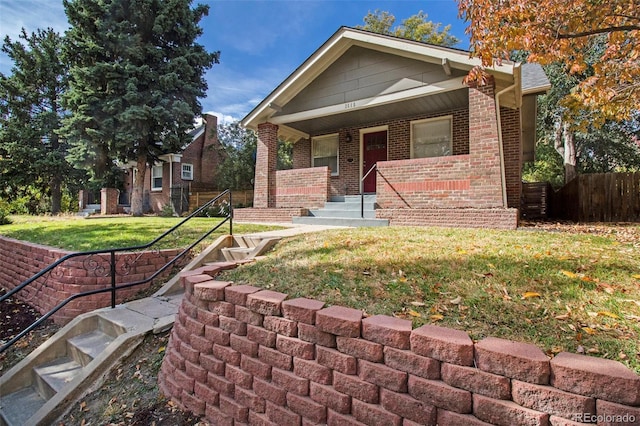 view of front facade featuring covered porch and a front lawn