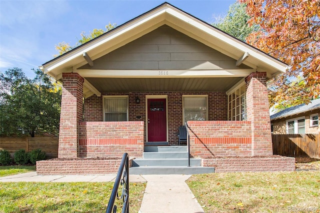 bungalow-style house with a front lawn and a porch