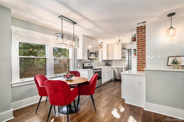 dining space featuring dark wood-type flooring