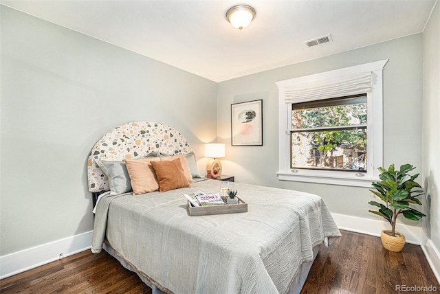 bedroom with dark hardwood / wood-style flooring