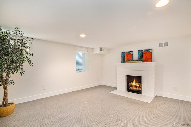 unfurnished living room with carpet flooring and a fireplace