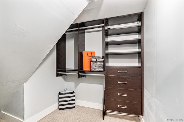 walk in closet featuring light colored carpet