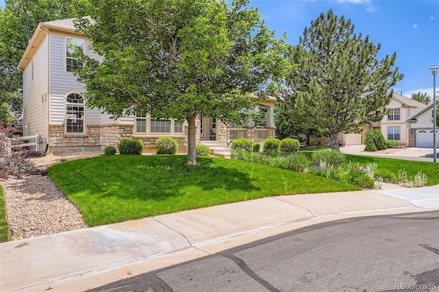 11638 Xavier Way, Westminster, CO 80031 - obstructed view of property with stone siding and a front yard