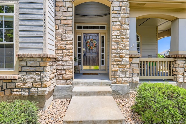 11638 Xavier Way, Westminster, CO 80031 - view of exterior entry featuring stone siding and covered porch