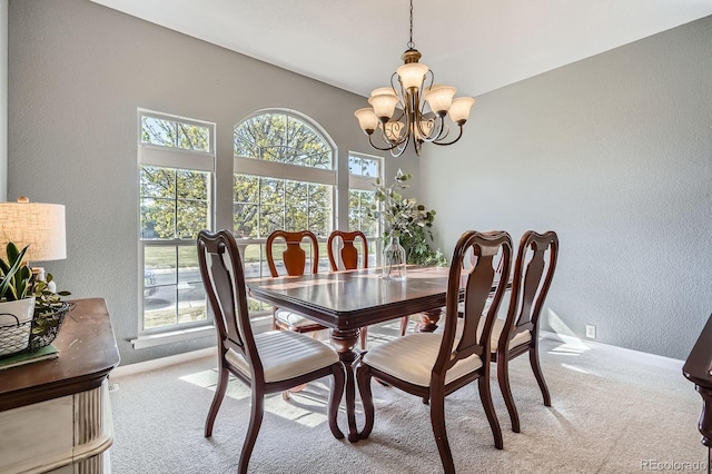 11638 Xavier Way, Westminster, CO 80031 - dining area featuring a textured wall, carpet flooring, and a chandelier