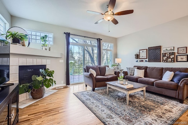11638 Xavier Way, Westminster, CO 80031 - living room with plenty of natural light, wood finished floors, ceiling fan, and a fireplace