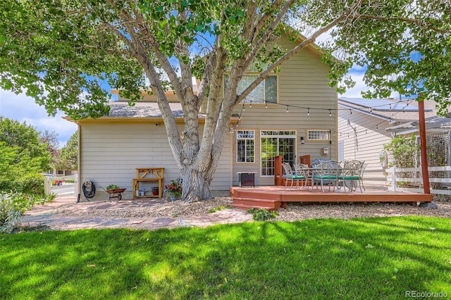 11638 Xavier Way, Westminster, CO 80031 - rear view of property featuring a wooden deck and a lawn