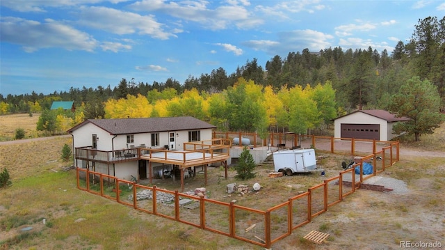 view of front facade with an outdoor structure, a garage, and a deck