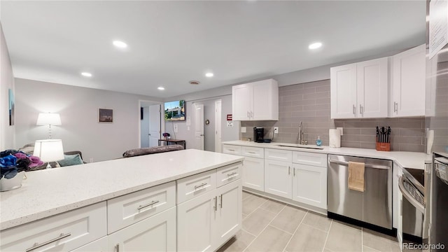7609 Sherman Pl, Denver, CO 80221 - kitchen with appliances with stainless steel finishes, sink, decorative backsplash, and white cabinets