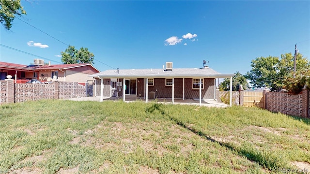 7609 Sherman Pl, Denver, CO 80221 - rear view of property featuring a lawn and a patio