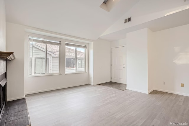 empty room featuring light hardwood / wood-style flooring and lofted ceiling