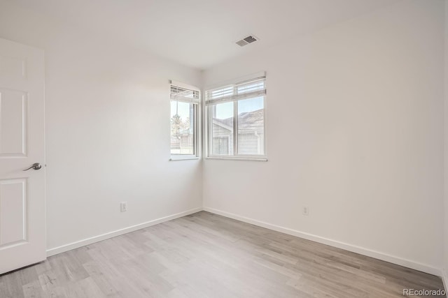 spare room featuring light hardwood / wood-style flooring