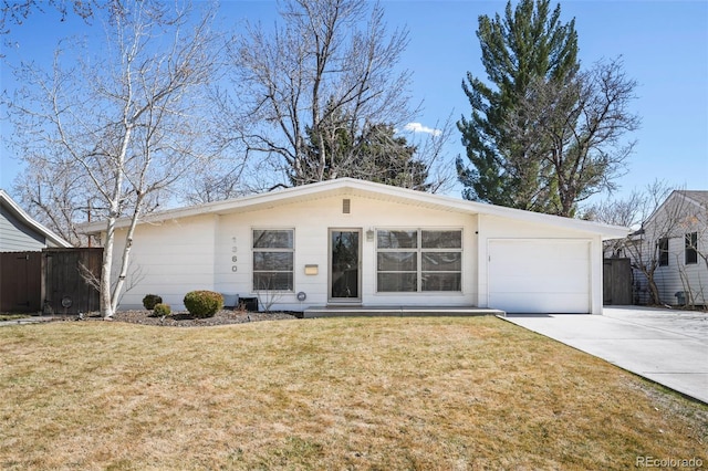 view of front of house with an attached garage, driveway, a front lawn, and fence