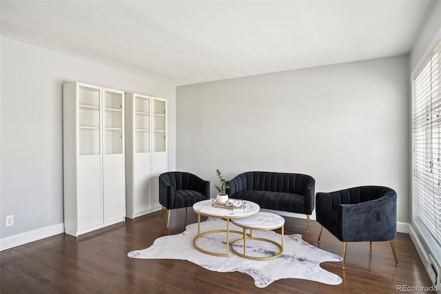 sitting room with wood finished floors and baseboards