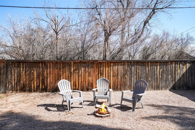 view of yard featuring a fire pit and fence