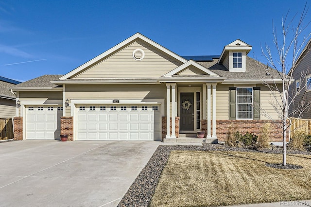 view of front of house with a garage, brick siding, and concrete driveway