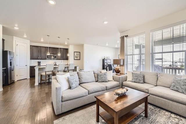 living area featuring wood finished floors and recessed lighting