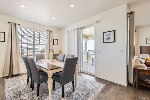 dining area featuring baseboards, visible vents, wood finished floors, and recessed lighting