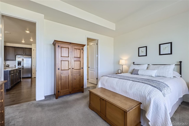 bedroom featuring stainless steel fridge and carpet floors
