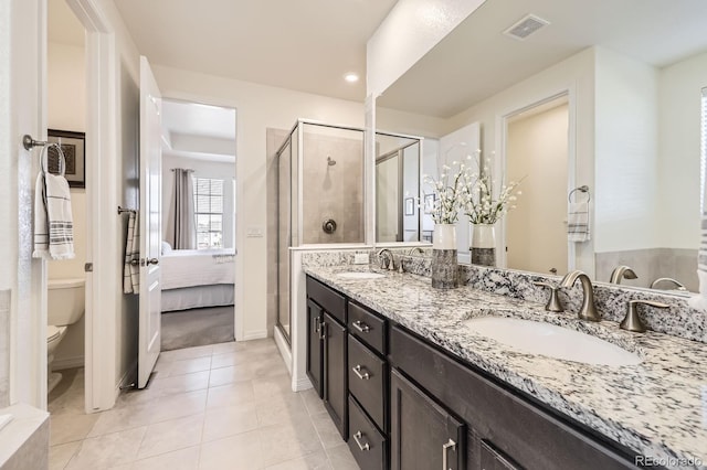 ensuite bathroom featuring a sink, visible vents, toilet, and a stall shower
