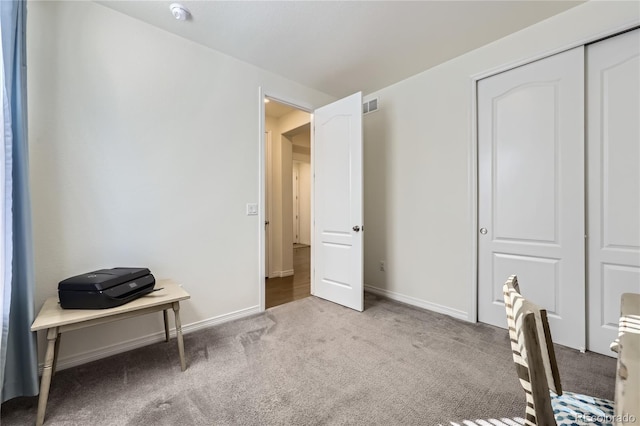 office area with baseboards, visible vents, and carpet flooring