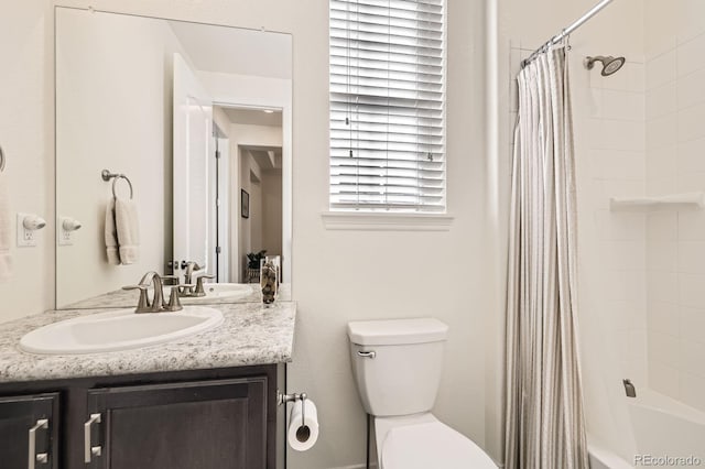 full bath with toilet, shower / bath combo with shower curtain, and vanity
