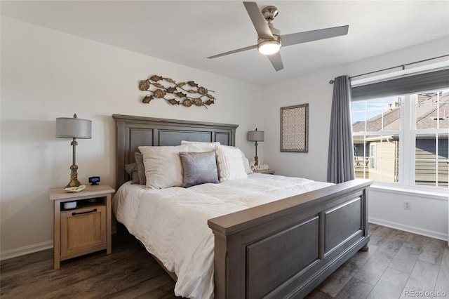 bedroom with multiple windows, ceiling fan, and dark hardwood / wood-style floors