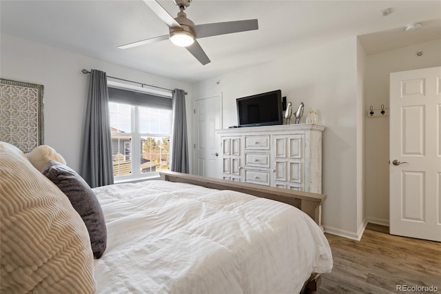 bedroom with ceiling fan and hardwood / wood-style floors