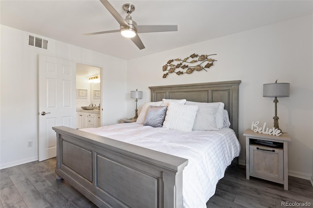 bedroom with ensuite bathroom, ceiling fan, and dark wood-type flooring